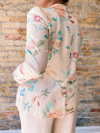 Floral-patterned shirt worn by a person against a brick wall.