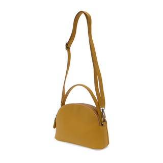 Close-up of adjustable crossbody strap and gold hardware details on the Larissa vegan leather bag. mustard color