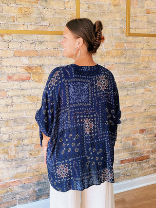 woman wearing a navy boho paisley print blouse with 7/8 sleeves and relaxed fit. 