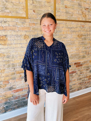 woman wearing a navy boho paisley print blouse with 7/8 sleeves and relaxed fit. 