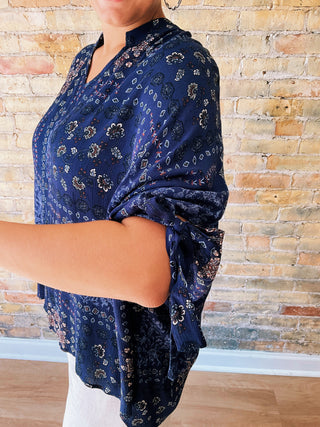 woman wearing a navy boho paisley print blouse with 7/8 sleeves and relaxed fit. 