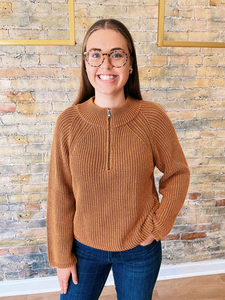 Woman wearing the Ella Sweater, a high neck zip-up ribbed knit sweater styled with denim for a polished casual look