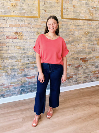 Jill Blouse – textured coral short sleeve top with elastic details on sleeves and flowy cut on the waist.