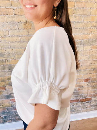 Everly Blouse – textured short sleeve top with elastic details on sleeves and flowy cut on the waist.