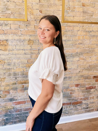 Everly Blouse – textured short sleeve top with elastic details on sleeves and flowy cut on the waist.