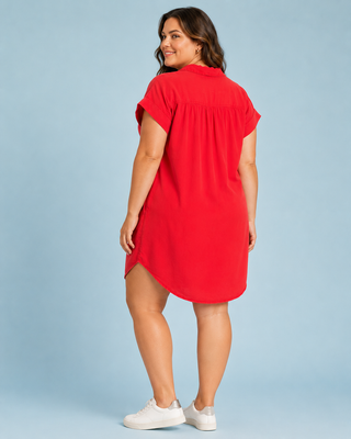 Woman wearing a red dress against a light blue background